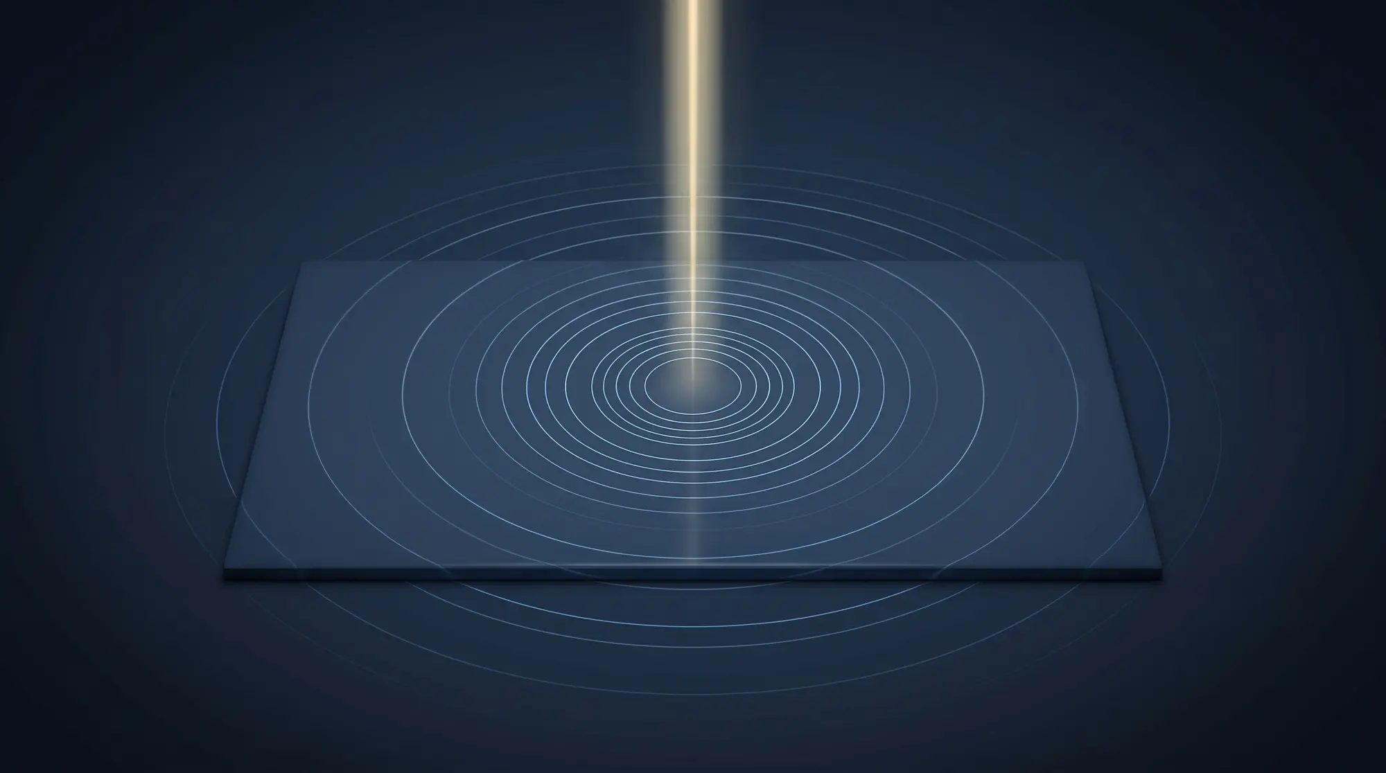 A narrow vertical column of pale gold light falls through a deep navy field and lands on a small, perfectly smooth rectangular tile whose surface is entirely blank and unmarked. A ring of fine concentric circles spreads outward from the point where the light meets the tile. No text, no numerals and no characters of any kind appear.
