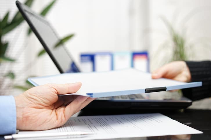 businessman and businesswoman are exchanging document or contract